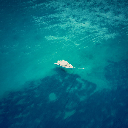 Top view of a boat in the blue seaの写真素材