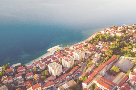 View from height to popular European resort town near the sea. Tonedの写真素材