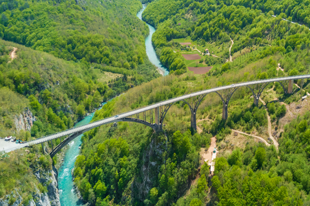 Road bridge over a river in the mountains, top viewの写真素材