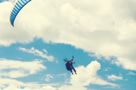Blue paraglider in the skyの写真素材