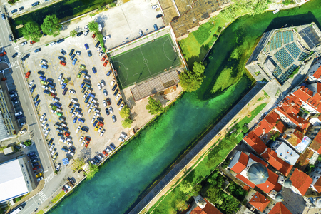 View from the drone of the city with parking for cars and basketball courtの写真素材