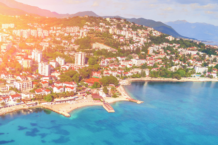 City in the mountains by the sea in the sunlight, top viewの写真素材