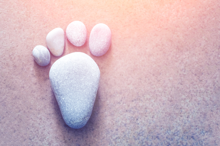 Footprint made of stones in the sunlightの写真素材