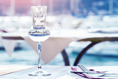 Glass with a rakia on a background of a marinaの写真素材