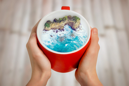 Ocean or sea in red cup. Summer holiday conceptの写真素材