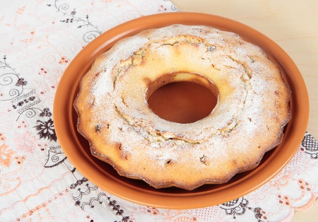 A delicious cake with raisins in a ceramic plate