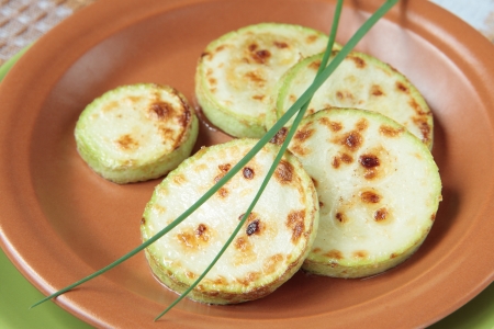 Fried zucchini with onion on ceramic plateの写真素材