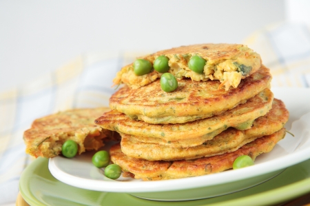 Pea flour fritters with green peas, carrots, parsleyの写真素材