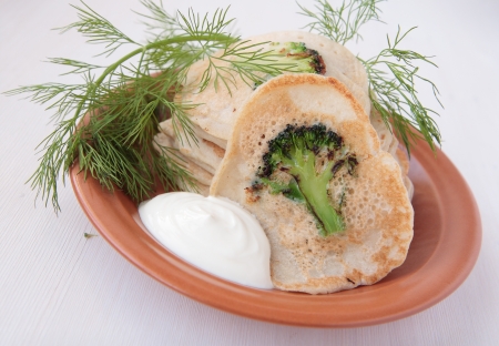Pancakes with broccoli, dill and sour creamの写真素材