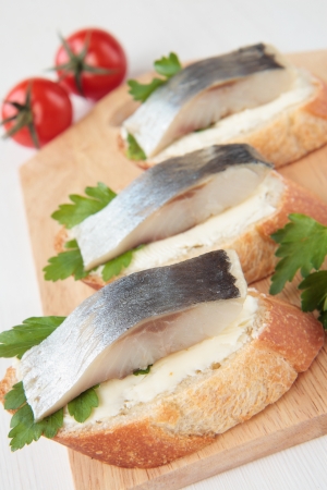 A slice of baguette with herring and parsley butterの写真素材