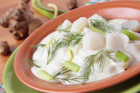 Jerusalem artichoke in milk sauce and dillの写真素材