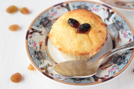 Cottage cheese gratin with raisins on plate and spoonの写真素材