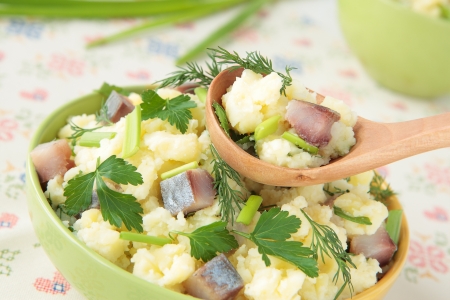 Mashed potatoes with pieces of herring, dill, parsley and chivesの写真素材