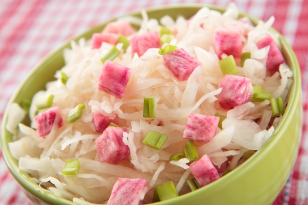 Salad of sauerkraut and pink radish in green bowlの写真素材