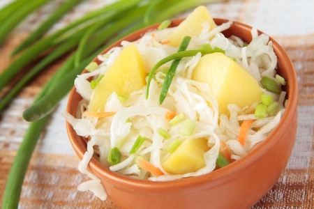 Potato salad with sauerkraut on a ruralの写真素材