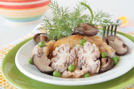 Fried beef brains with mushrooms and peasの写真素材