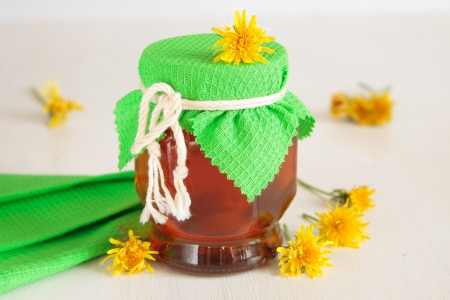 Honey of dandelions inglass jar, tied with a ropeの写真素材