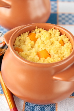 Two pots of millet porridge with piece of pumpkinの写真素材