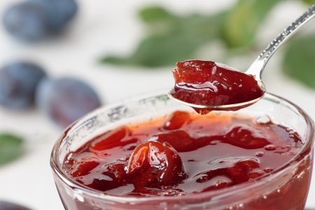 Plum jam in a glass bowl, spoon, plumsの写真素材