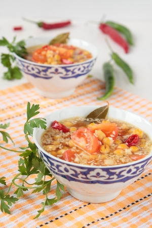 Soup of chickpeas and tomatoes in a bowlの写真素材
