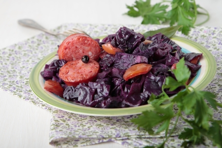 Stewed red cabbage with fried sausage on plateの写真素材