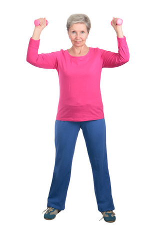 Cheerful elderly woman doing gymnastic exercises vigorouslyの写真素材