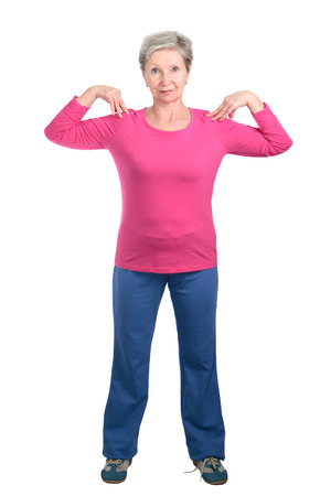 Cheerful elderly woman doing gymnastic exercises vigorouslyの写真素材