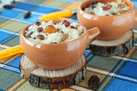Sweet casserole of rice and raisins in two bowlsの写真素材