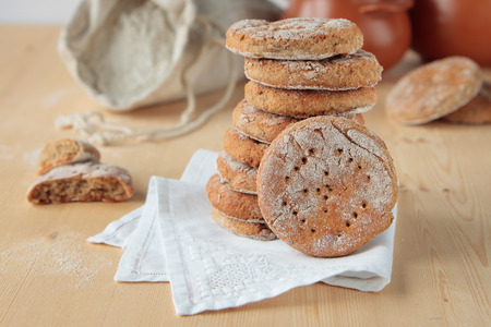 Rye bread on napkin, flour in the bag, pots