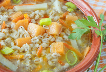 Soup of turnip and pearl barley with leek and carrotsの写真素材