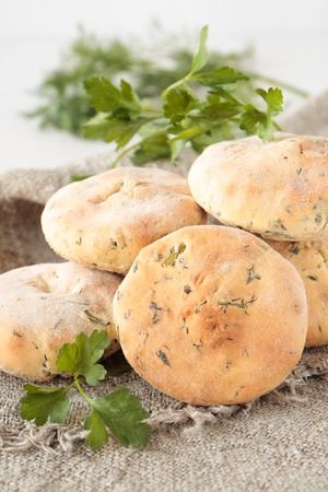 Flat bread of wheat flour with dill, parsley and cilantroの写真素材