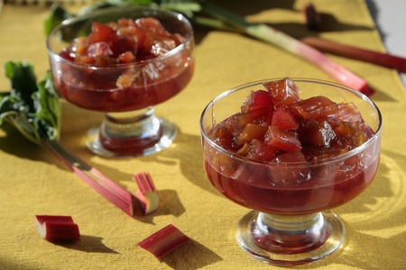 Two glasses with rhubarb jam on a yellow napkinの写真素材