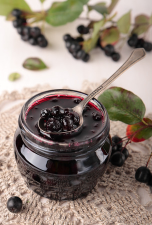 Black chokeberry jam in a small glass jarの写真素材