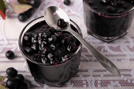 Black chokeberry jam in two small glassesの写真素材