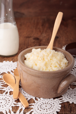 Ceramic saucepan with sweet milk rice porridge and clarified butterの写真素材