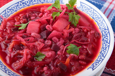 Soup of sauerkraut with beet, pearl barley and potatoes in a bowl