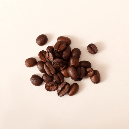 Closeup photo of coffee beans on white tableの写真素材