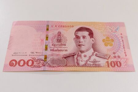 Close up of 100 Thai baht banknote texture on white background.