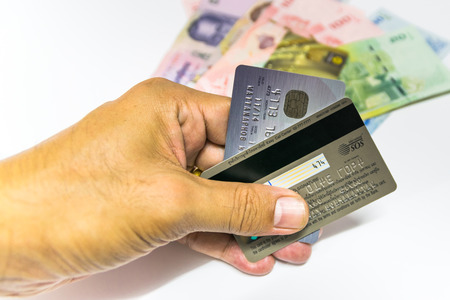 A small plastic card issued by a bank, business, etc., allowing the holder to purchase goods or services on credit.のeditorial素材