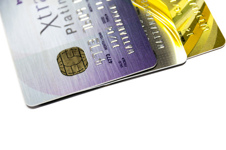 A small plastic card issued by a bank, business, etc., allowing the holder to purchase goods or services on credit.の写真素材