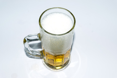 Beer golden white bubbles in the glass.の写真素材
