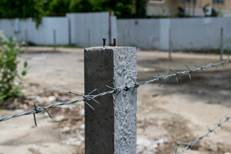 wire with clusters of short, sharp spikes set at intervals along it, used to make fences or in warfare as an obstruction.の写真素材