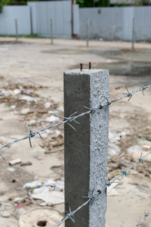 wire with clusters of short, sharp spikes set at intervals along it, used to make fences or in warfare as an obstruction.の写真素材