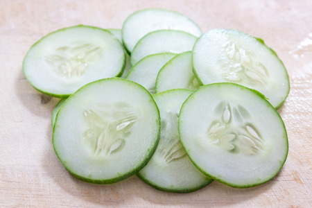 A long, green-skinned fruit with watery flesh, usually eaten raw in salads or pickled.の写真素材
