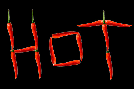 Fresh red peppers and sliced lemon isolated on black background.の写真素材