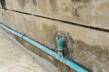 Water pipes on the vintage stone wall.の写真素材