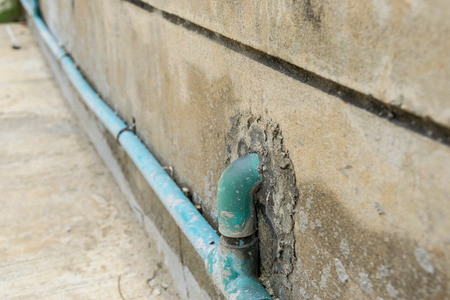 Water pipes on the vintage stone wall.の写真素材
