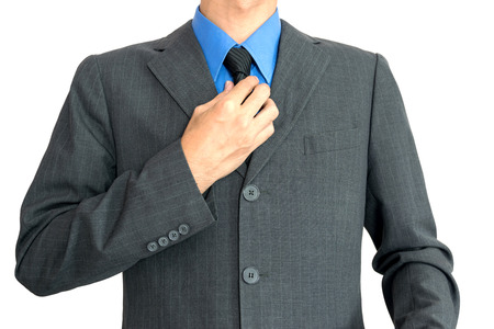 Young businessman Wearing a blue shirt, black tie and then covered with a gray suit.の写真素材