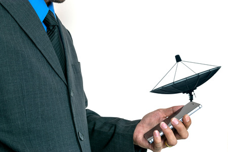 Young businessman using a smart phone to run his business.の写真素材