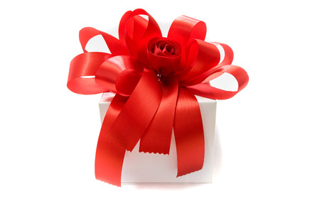 Gift box tied with a red bow on white background.の写真素材